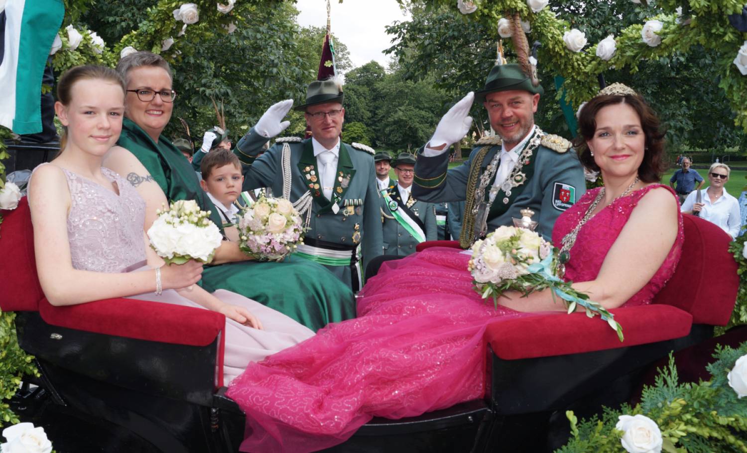 In der Königskutsche haben zum Schützenfest 2019  (von links) Edelmädel Jolie Täubert, Ehrendame Eva Göbel, Edelknabe Elias Schlüter sowie Frank und Nadine Täubert Platz genommen. Im Hintergrund grüßt  Zeremonienmeister Sebastian Tofall.