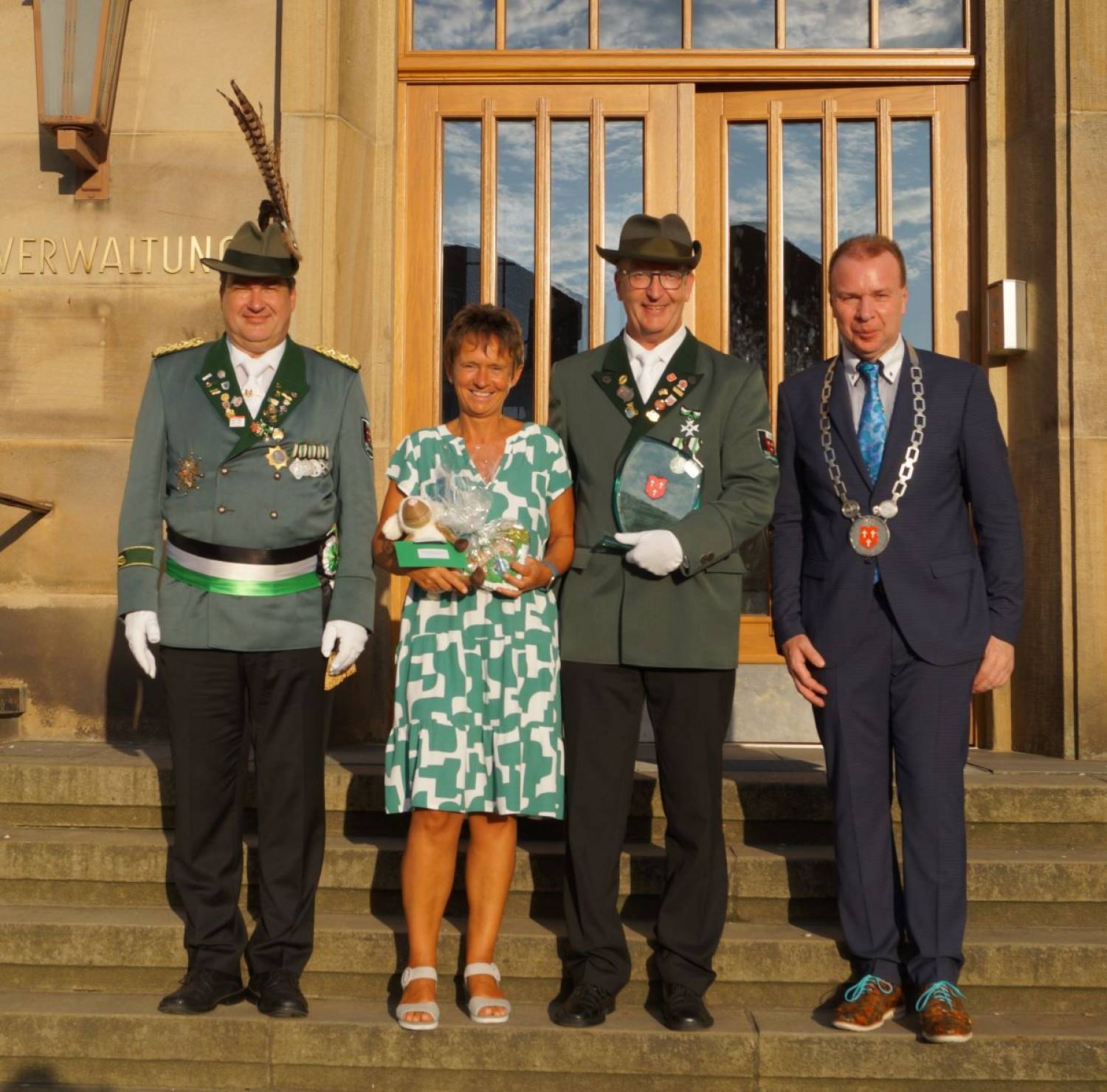 Auf dem Foto werden Meinolf Alewelt und seine Lebensgefährtin  Anja Glowik von Oberst Guido Düsing (links)   und Bürgermeister Ulrich Lange in die Mitte genommen.